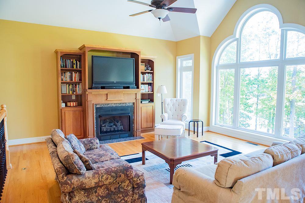 159 Duck Pointe Drive Roxboro, NC 27574 - Photo 7 of 30 a living room with furniture a flat screen tv and a fireplace