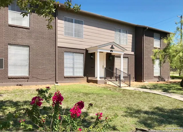 a front view of a house with flowers