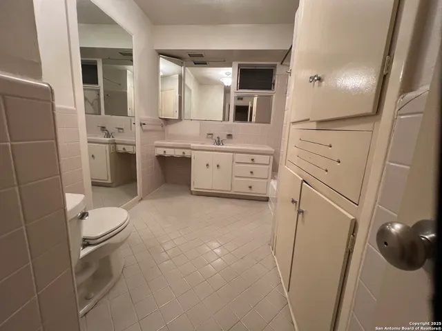 a bathroom with a sink a toilet and mirror