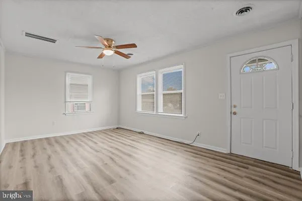 a view of empty room with ceiling fan