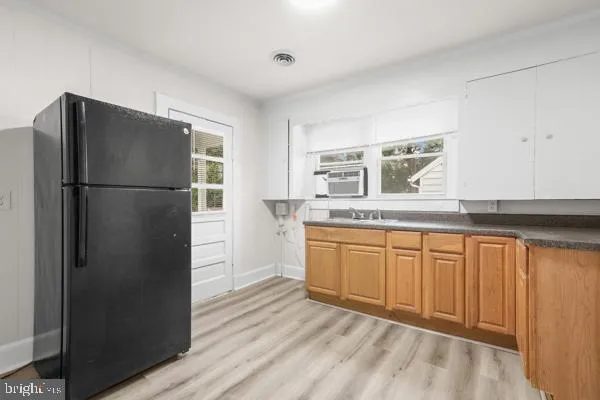 a kitchen with stainless steel appliances granite countertop a refrigerator sink and cabinets