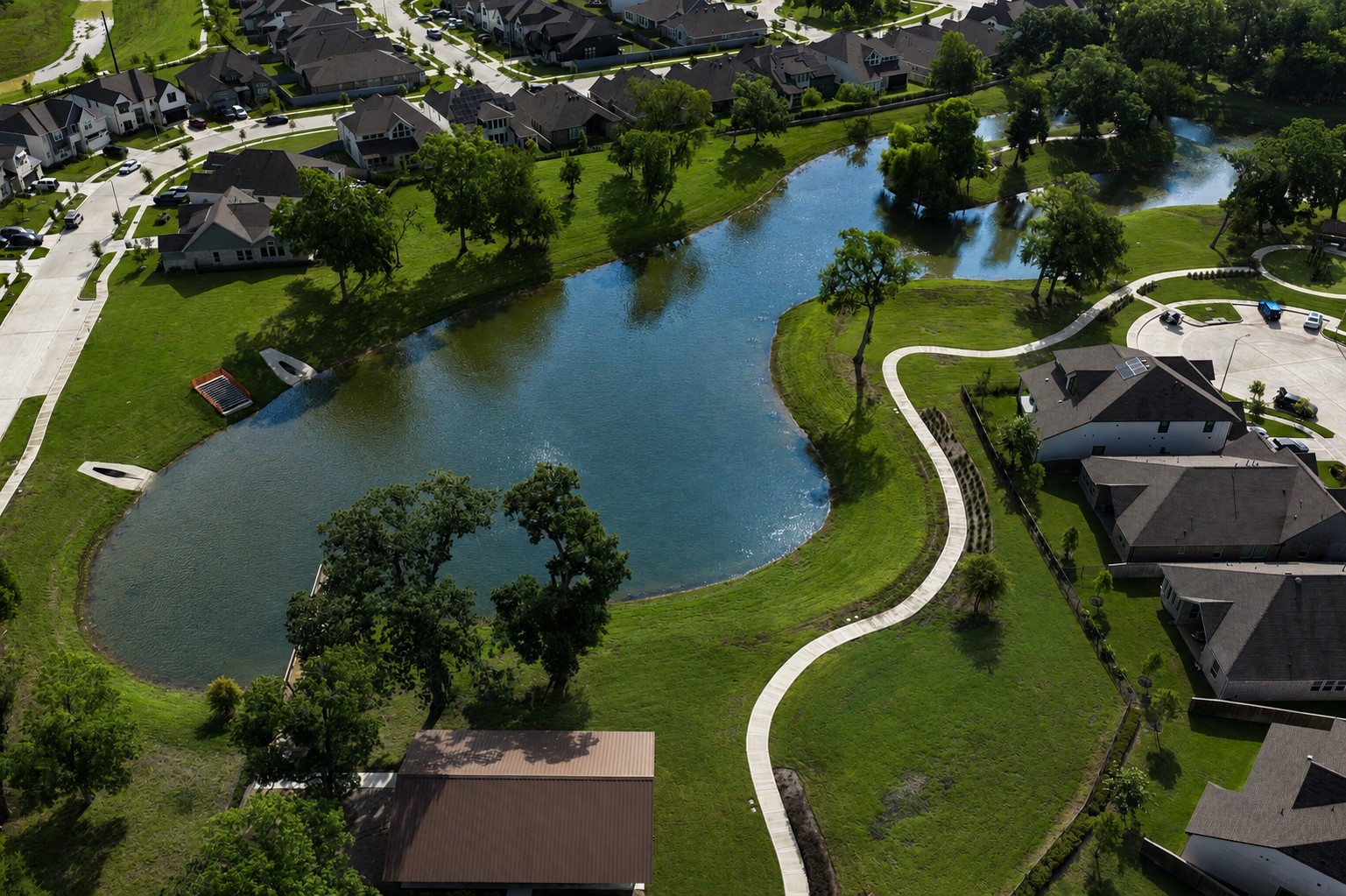 32607 Fly Fish Way Fulshear, TX 77441 - Photo 40 of 41 Aerial view highlights the neighborhood's scenic waterfront, beautifully landscaped walking trails, and inviting open spaces.