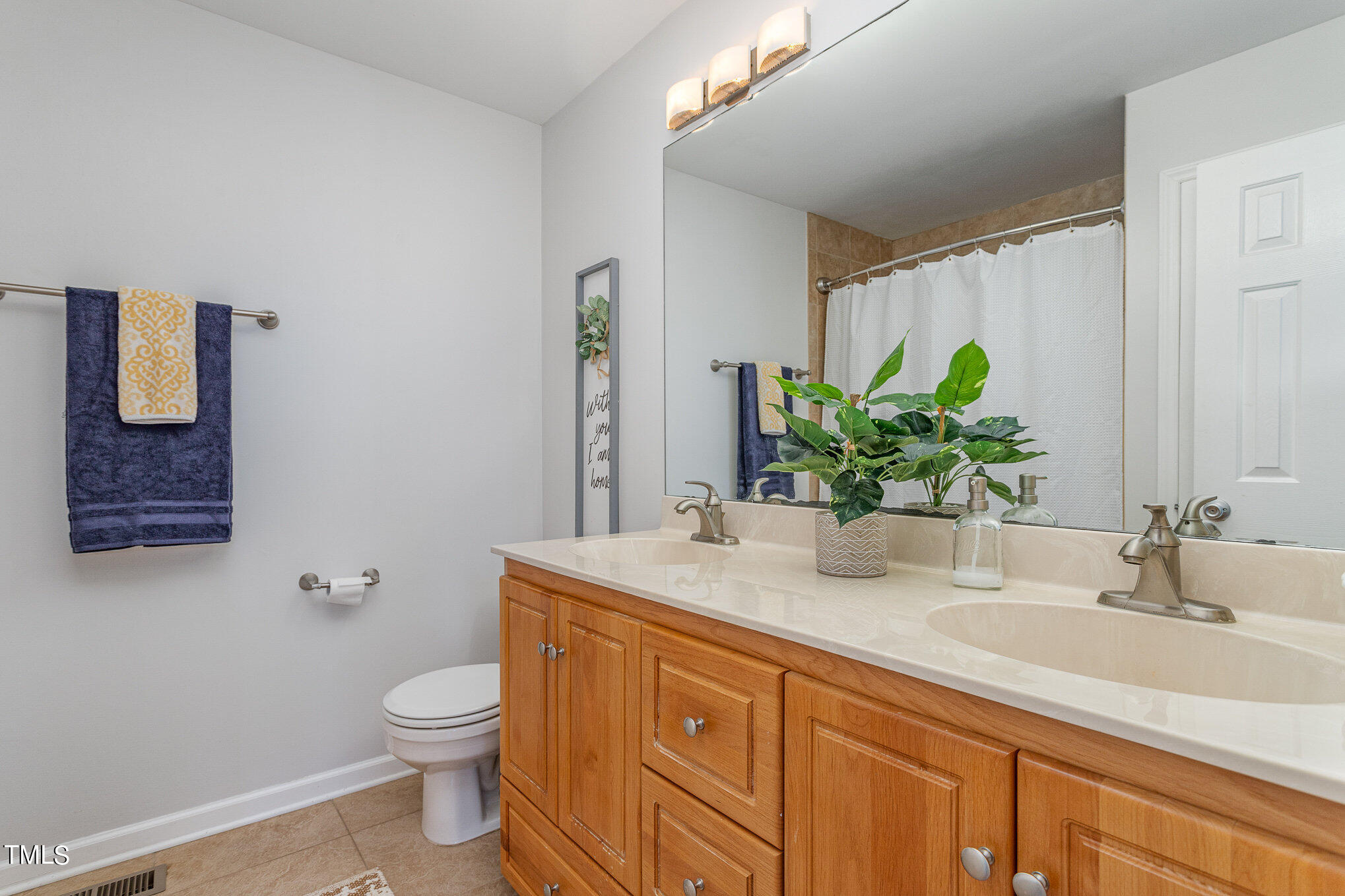 6309 Bridgemont Lane Willow Spring, NC 27592 - Photo 15 of 27 a bathroom with a granite countertop sink a toilet and mirror