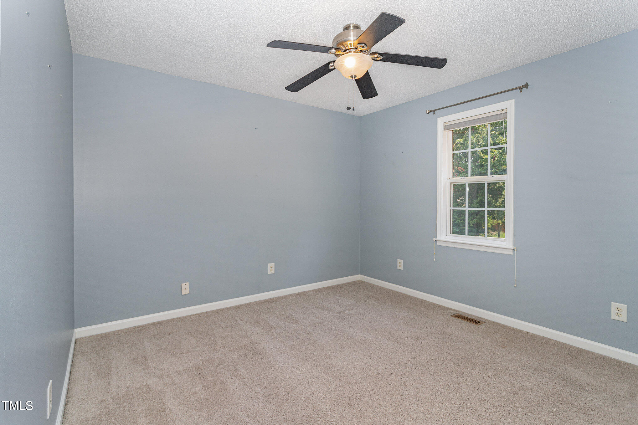 6309 Bridgemont Lane Willow Spring, NC 27592 - Photo 18 of 27 an empty room with a window and a fan