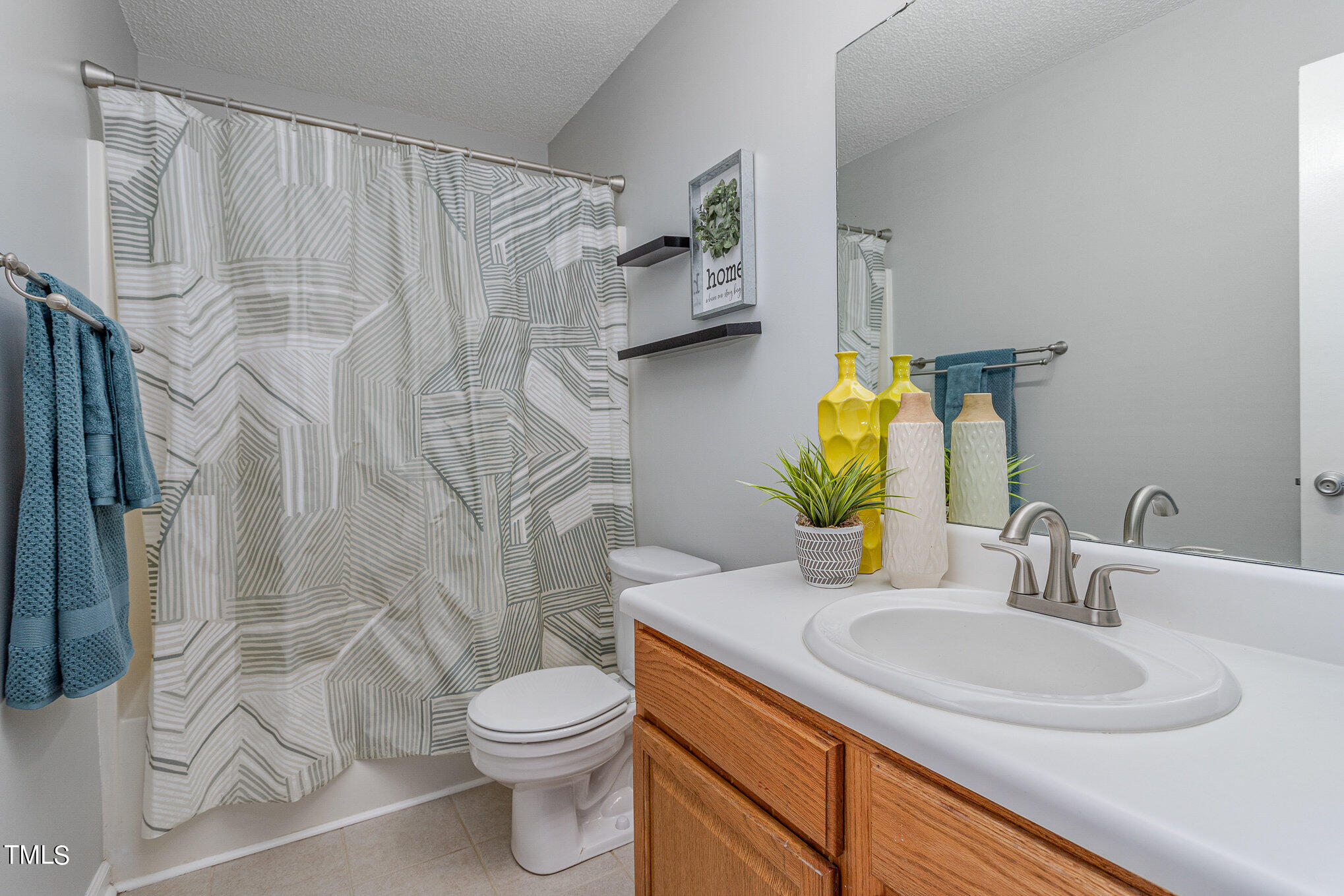 6309 Bridgemont Lane Willow Spring, NC 27592 - Photo 20 of 27 a bathroom with a granite countertop sink toilet and shower