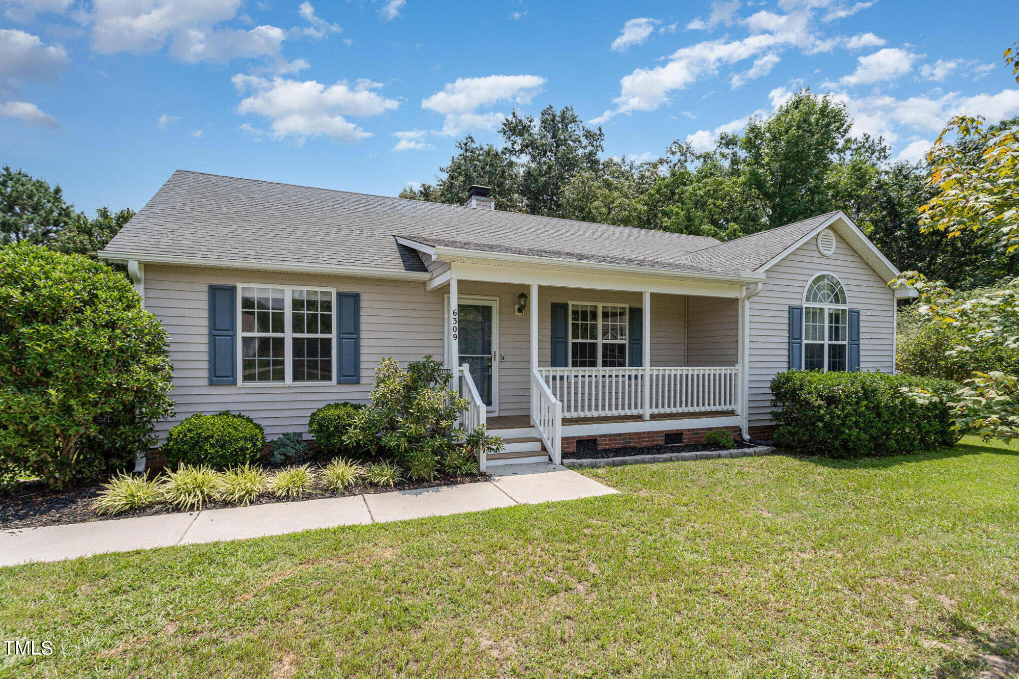 6309 Bridgemont Lane Willow Spring, NC 27592 - Photo 3 of 27 a front view of a house with a yard and outdoor seating