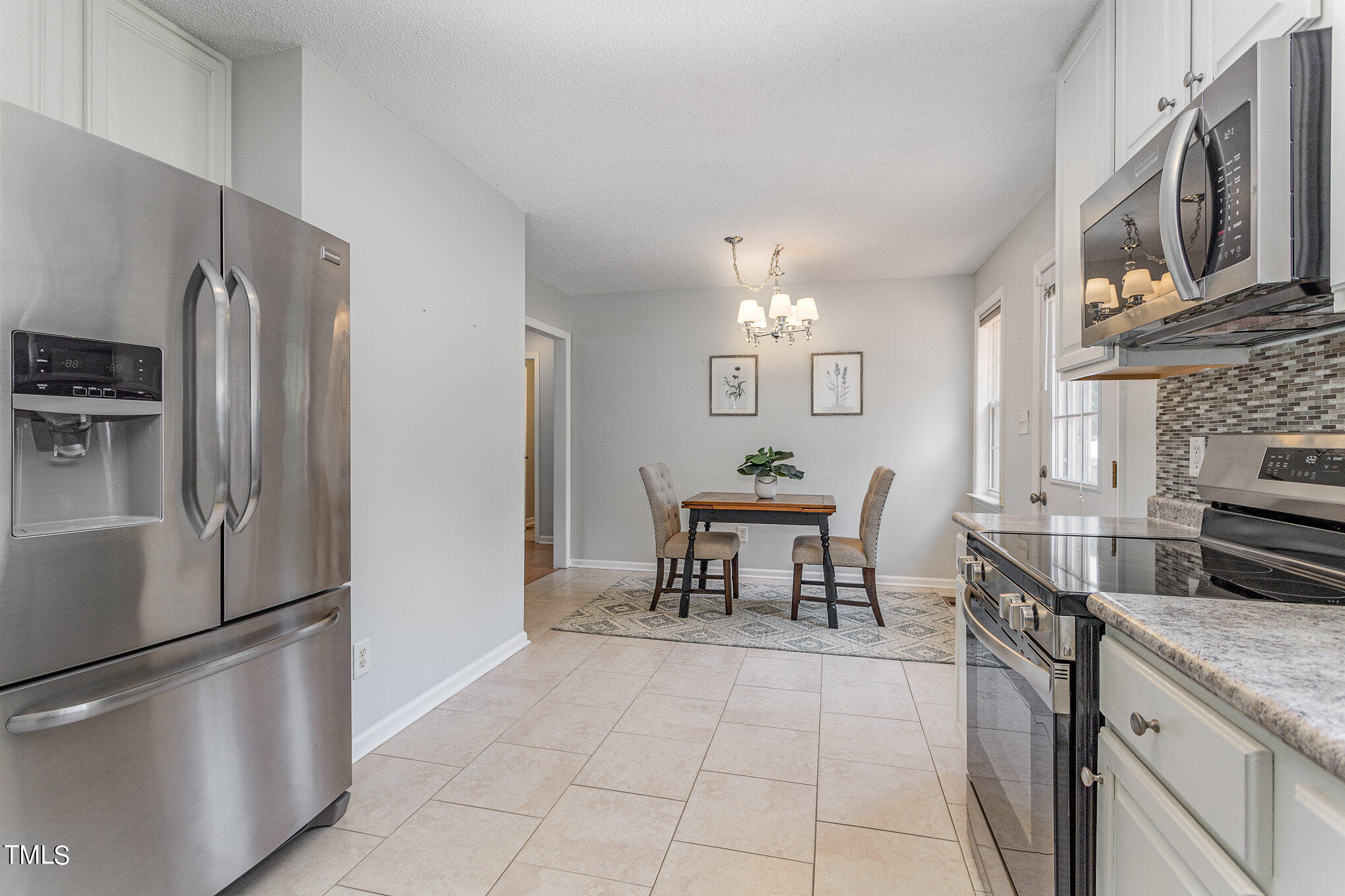 6309 Bridgemont Lane Willow Spring, NC 27592 - Photo 9 of 27 a kitchen with stainless steel appliances granite countertop a refrigerator and a stove top oven