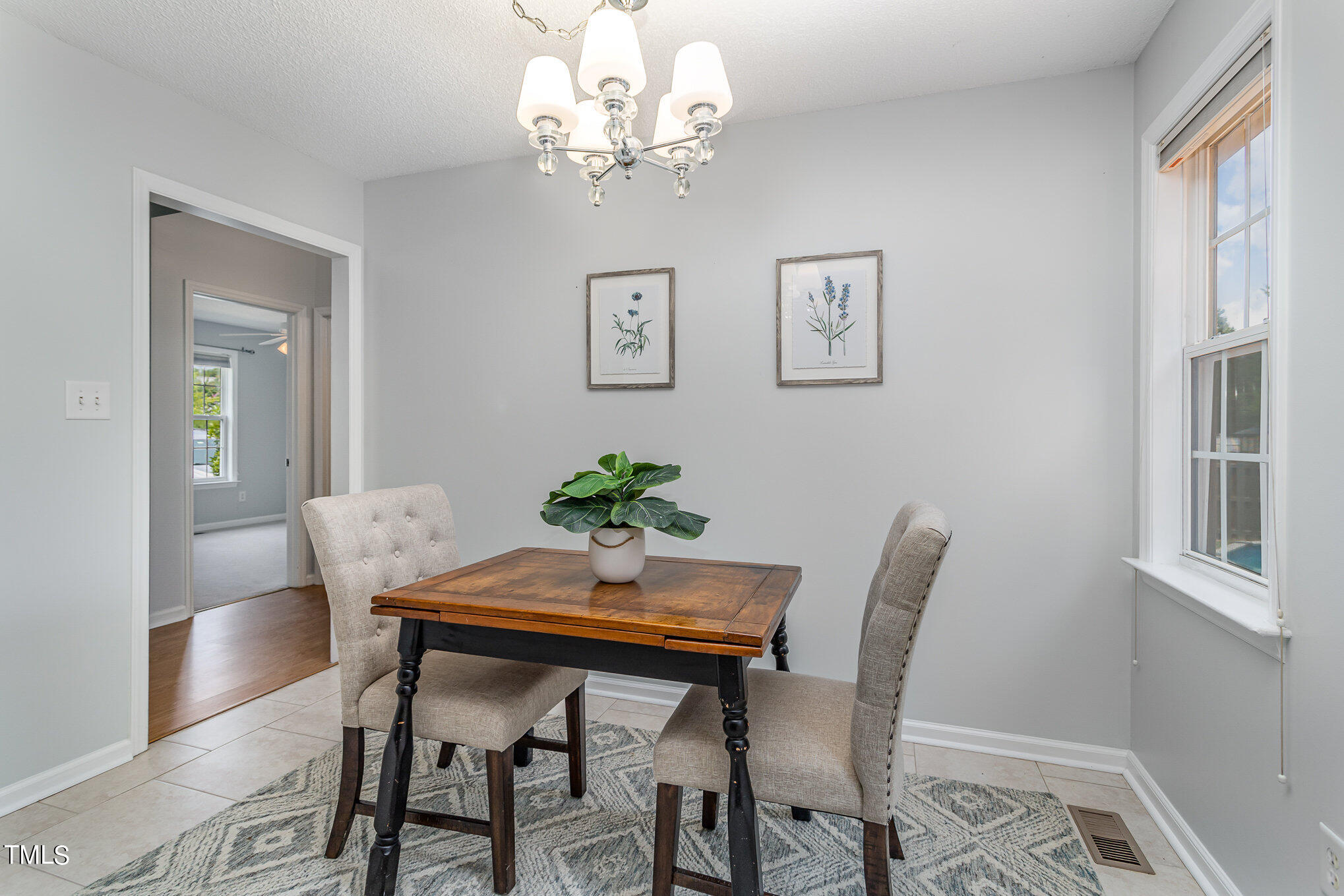 6309 Bridgemont Lane Willow Spring, NC 27592 - Photo 10 of 27 a view of a dining room with furniture and chandelier