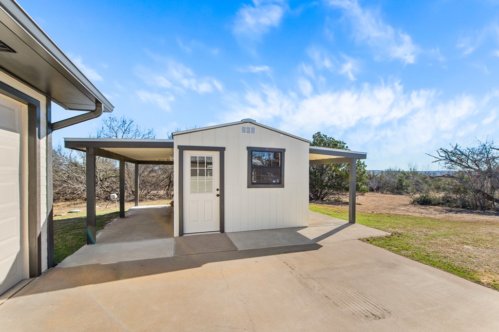 622 Paradise Ranch Road Fredericksburg, TX 78624 - Photo 14 of 90 a view of a house with backyard and porch