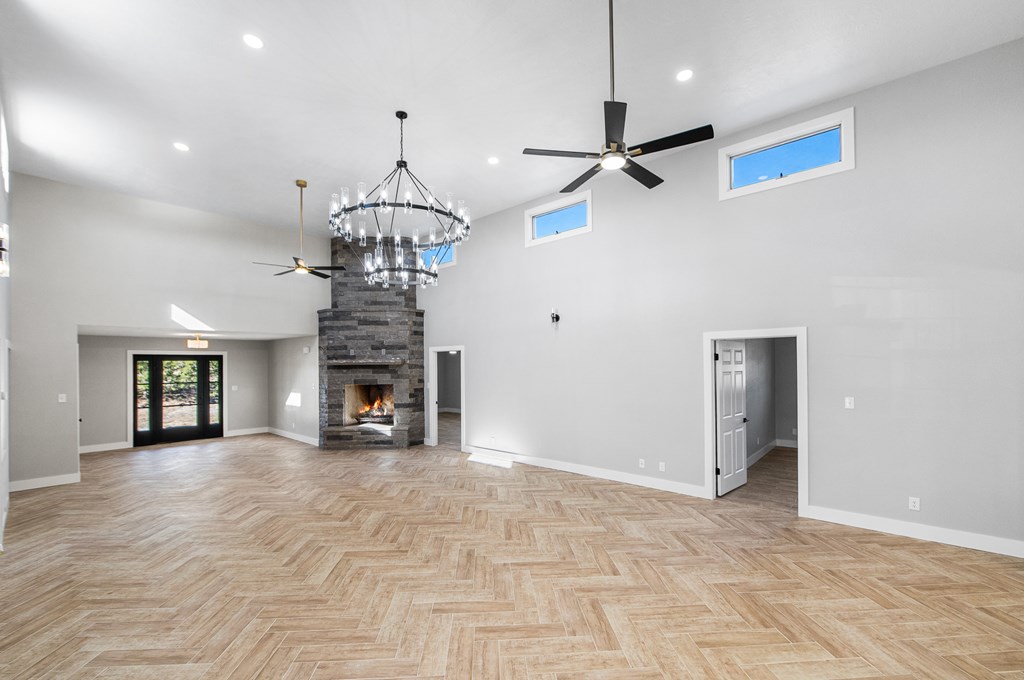 622 Paradise Ranch Road Fredericksburg, TX 78624 - Photo 18 of 90 a view of a livingroom with a chandelier a fireplace and a chandelier