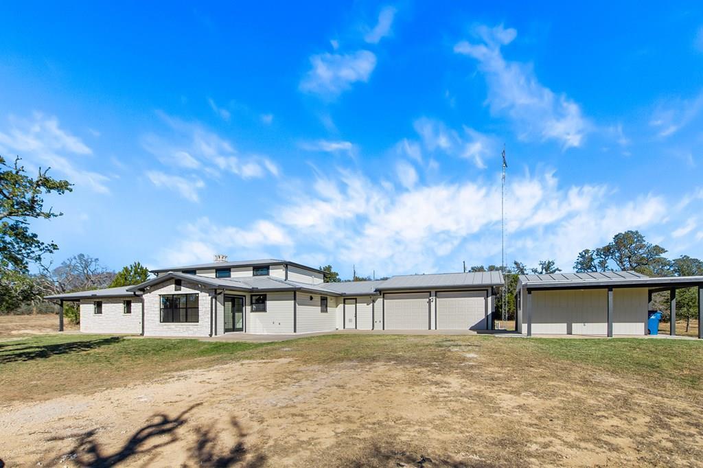 622 Paradise Ranch Road Fredericksburg, TX 78624 - Photo 5 of 90 a front view of a house with a yard