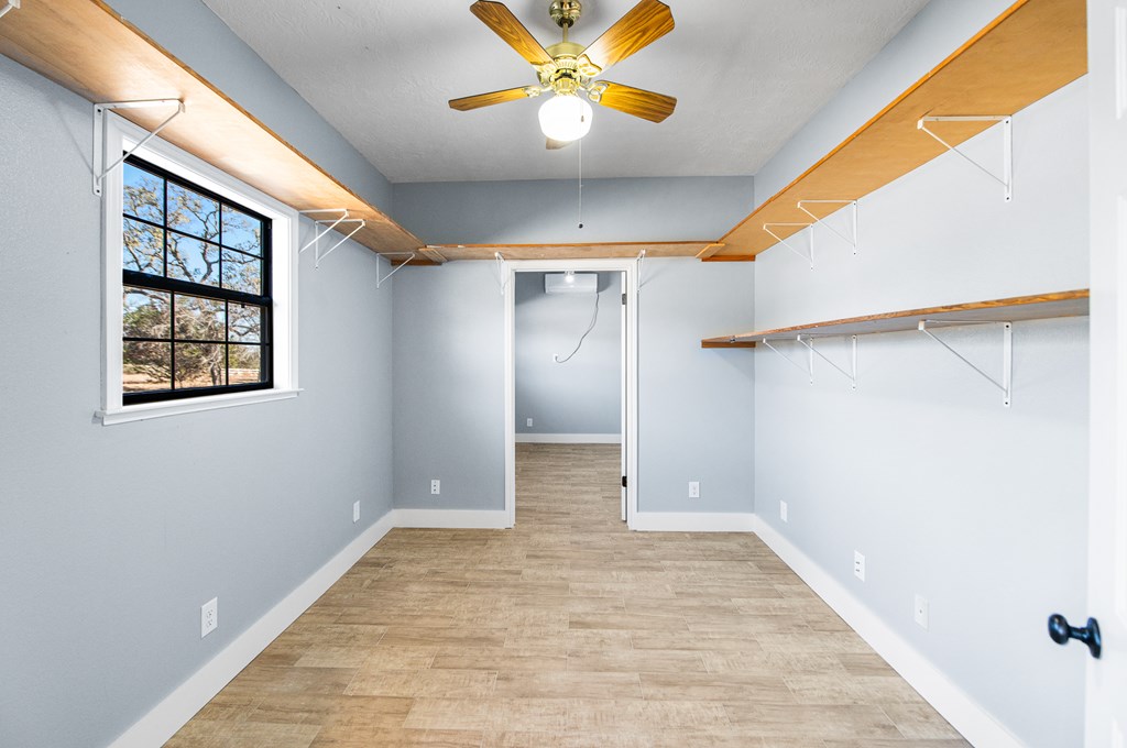622 Paradise Ranch Road Fredericksburg, TX 78624 - Photo 57 of 90 a view of an empty room with window and wooden floor