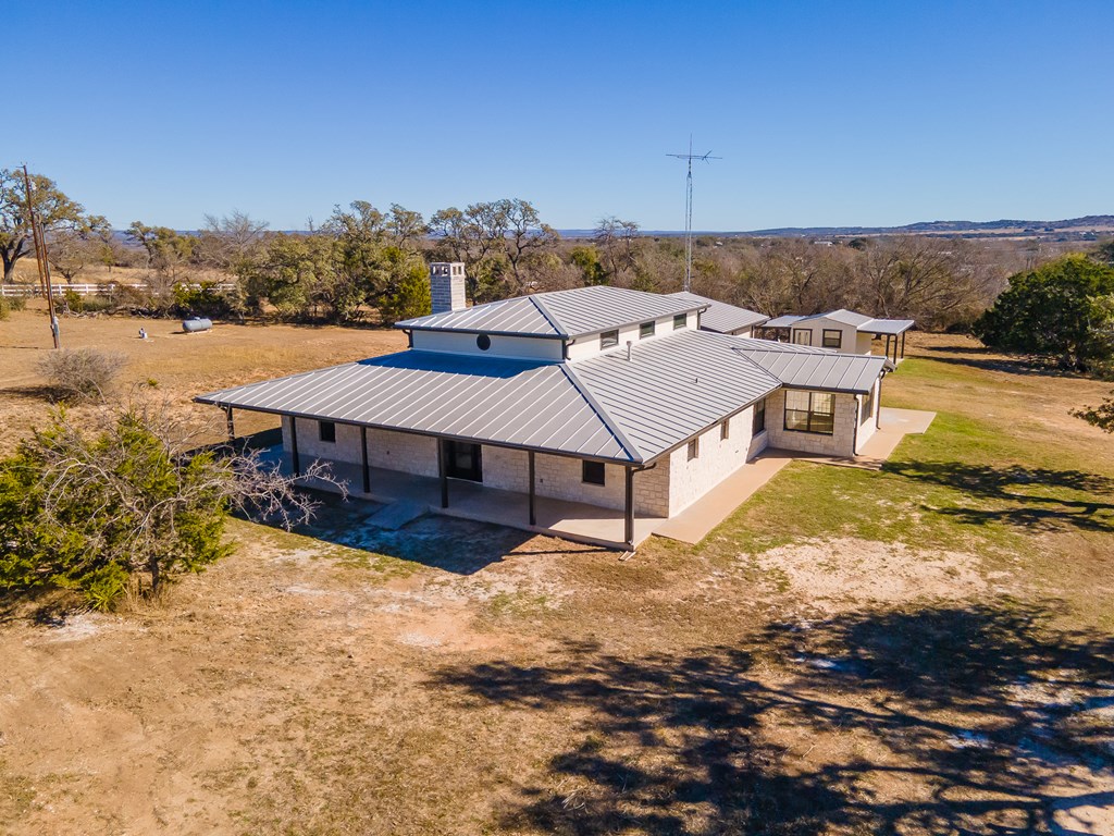622 Paradise Ranch Road Fredericksburg, TX 78624 - Photo 71 of 90 an aerial view of a house with a yard swimming pool and mountain view