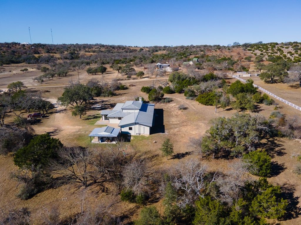 622 Paradise Ranch Road Fredericksburg, TX 78624 - Photo 76 of 90 an aerial view of a house with a lake view