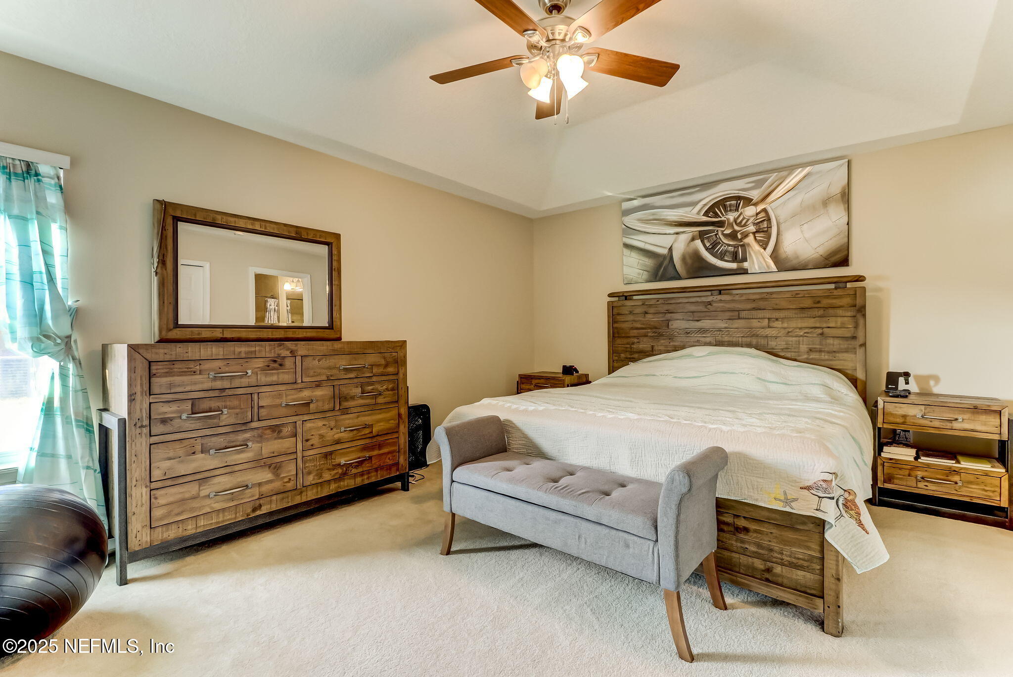 94055 Last Lane Yulee, FL 32097 - Photo 16 of 30 a bedroom with a bed and a chandelier