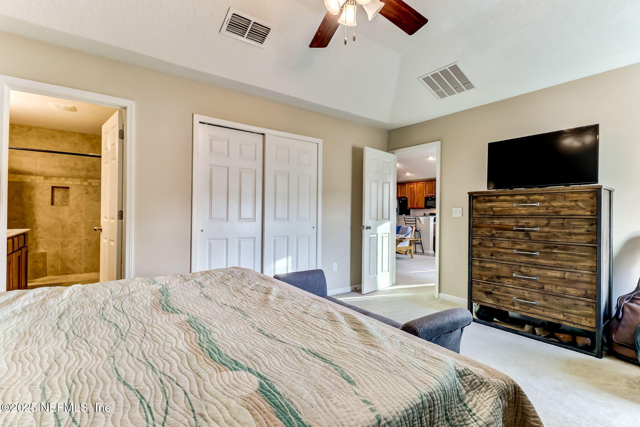 94055 Last Lane Yulee, FL 32097 - Photo 17 of 30 a bedroom with a bed and a flat screen tv