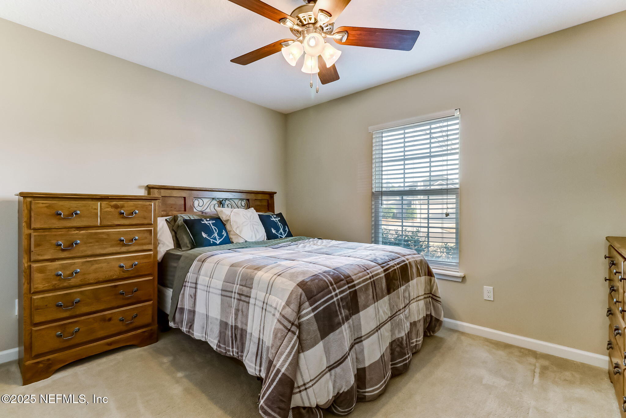 94055 Last Lane Yulee, FL 32097 - Photo 19 of 30 a bedroom with a bed and a chandelier