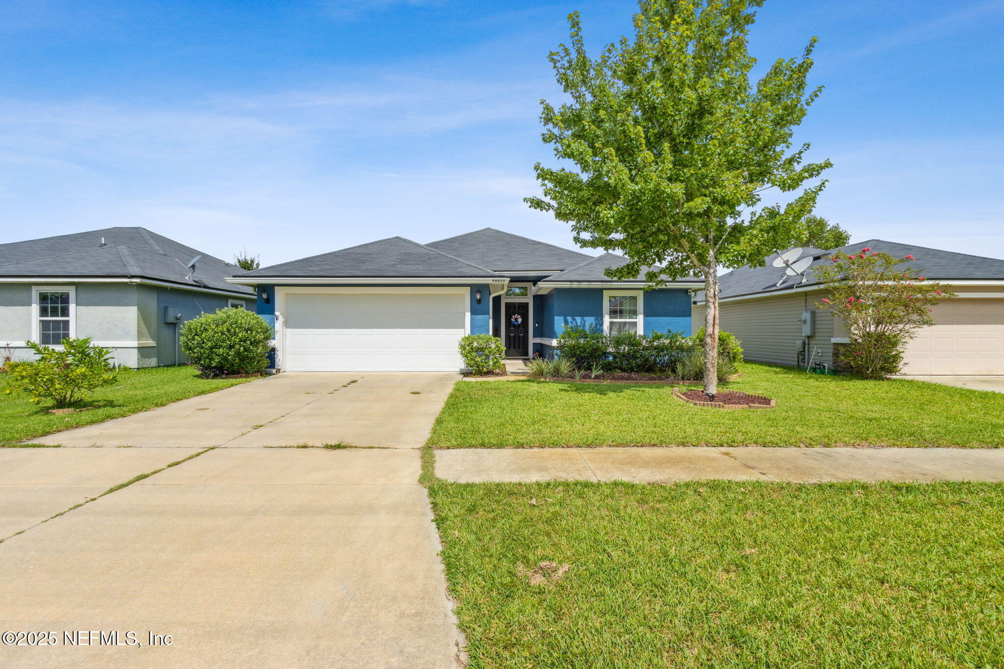 94055 Last Lane Yulee, FL 32097 - Photo 2 of 30 a front view of a house with a yard and garage