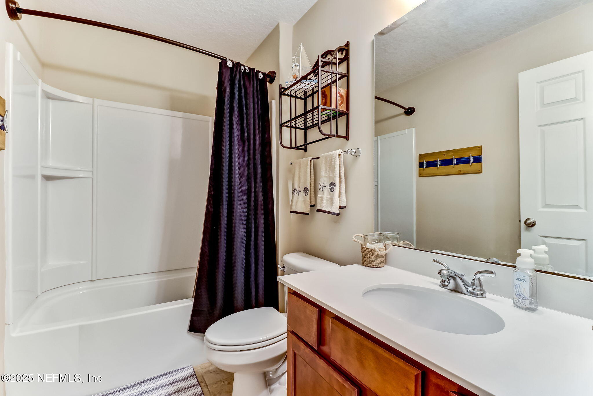 94055 Last Lane Yulee, FL 32097 - Photo 23 of 30 a bathroom with a sink a toilet and shower