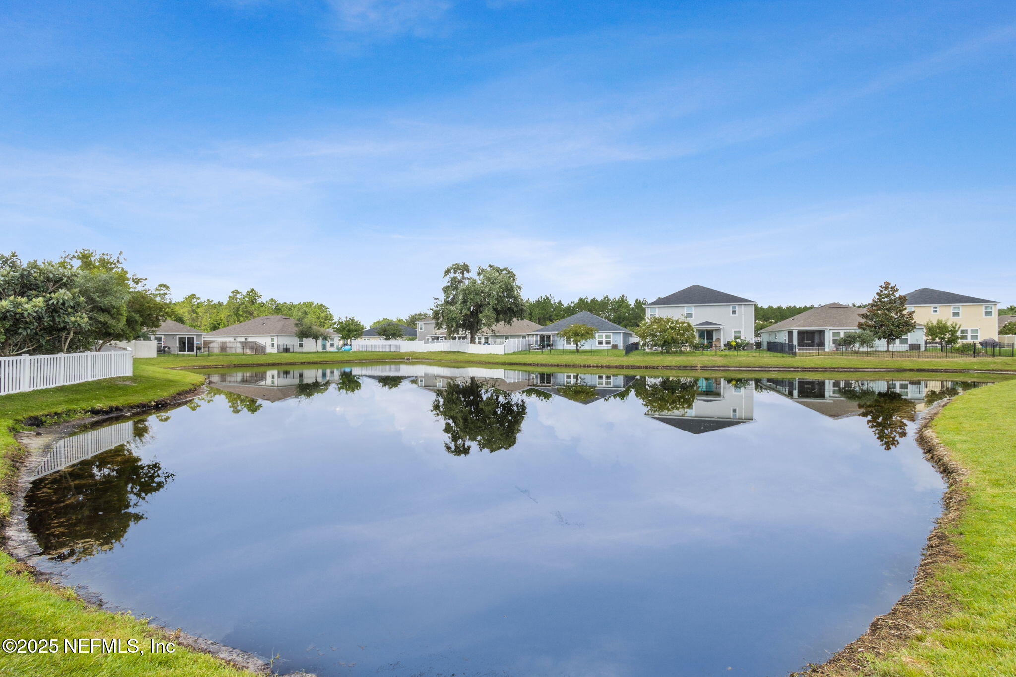 94055 Last Lane Yulee, FL 32097 - Photo 28 of 30 a view of a lake with houses in the back