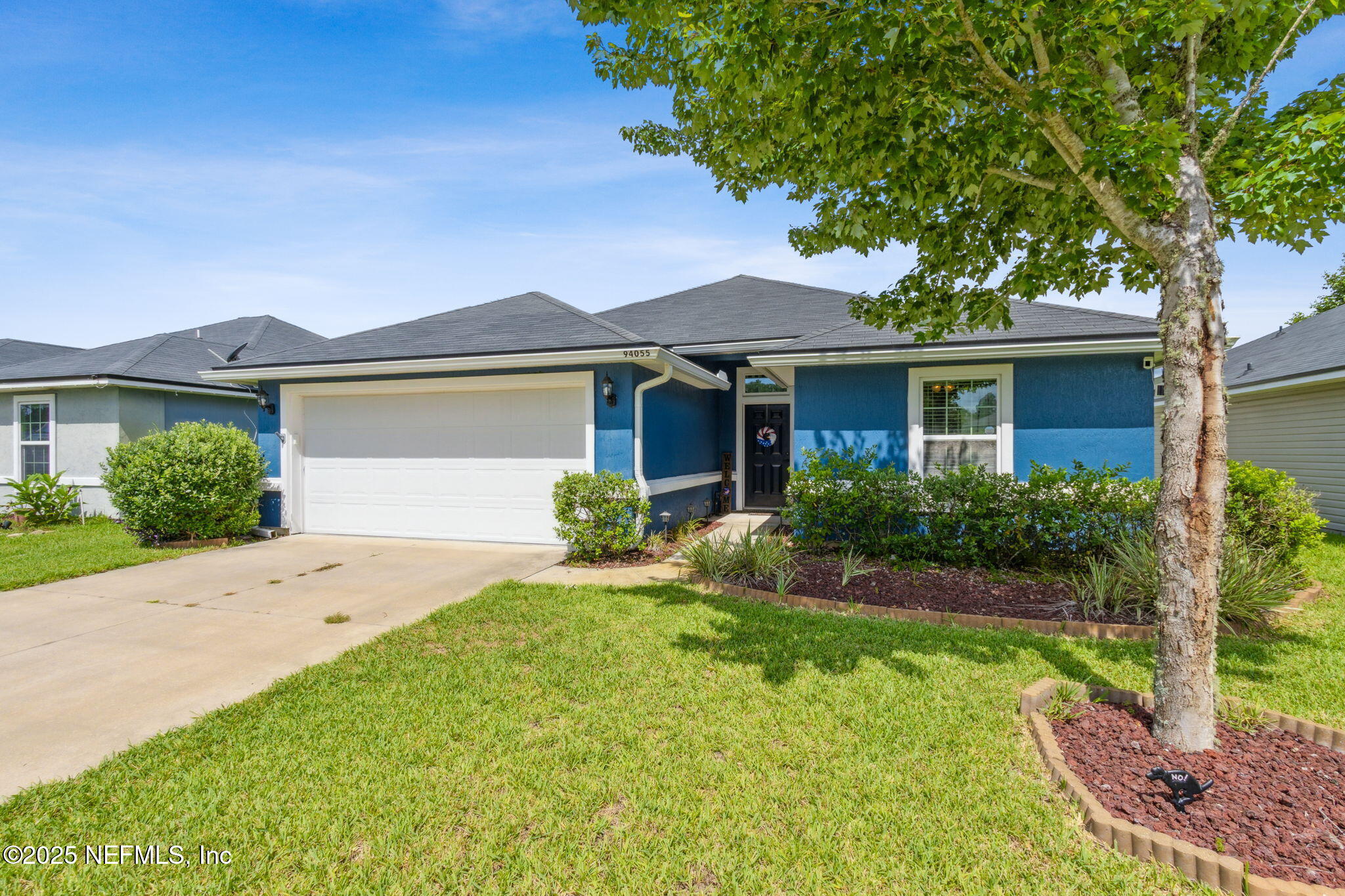 94055 Last Lane Yulee, FL 32097 - Photo 3 of 30 a front view of a house with a yard