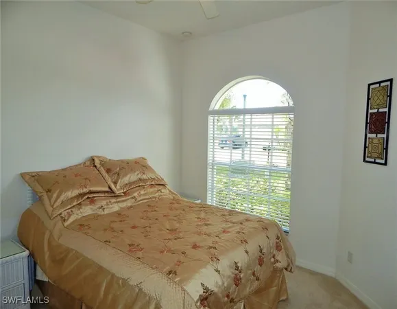 a large bed sitting in a bedroom next to a window