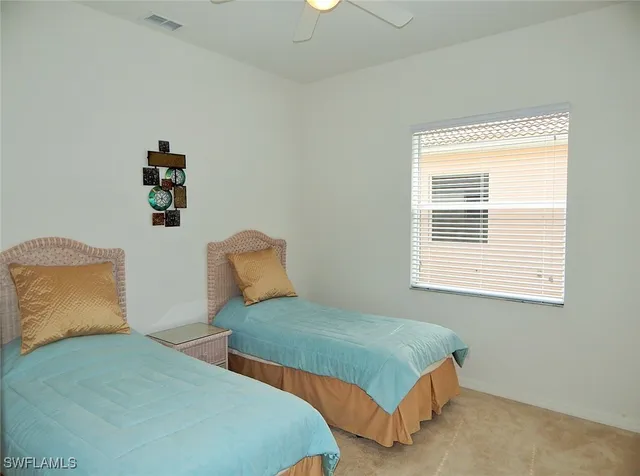 a bedroom with two beds and a window