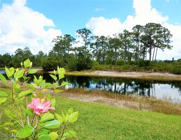 a view of a lake with a house in the background