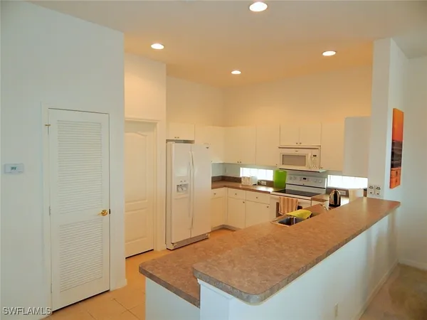 a kitchen with sink refrigerator and stove