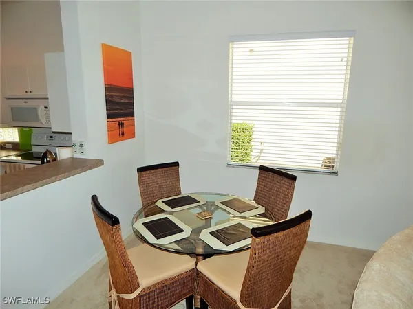 a view of a dining room with a table and chairs