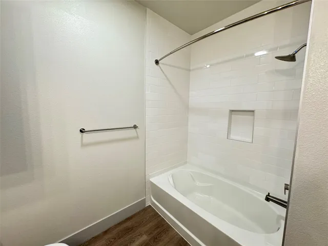 a bathroom with a tub and shower
