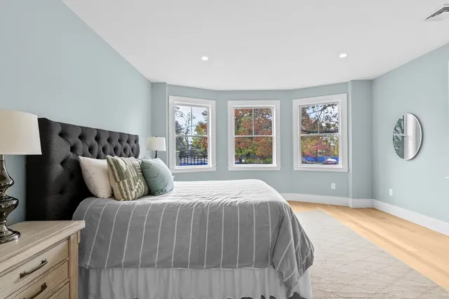 a bedroom with a large bed and a window