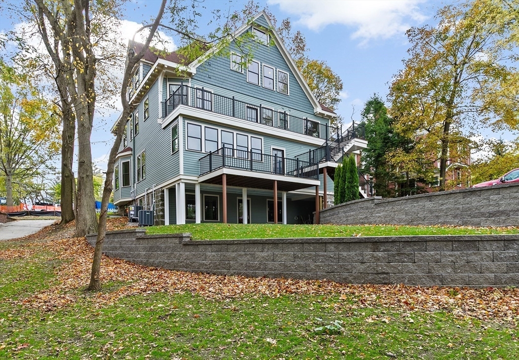 90 Addington Road, Unit 1 Brookline, MA 02445 - Photo 20 of 21 a front view of a house with a yard