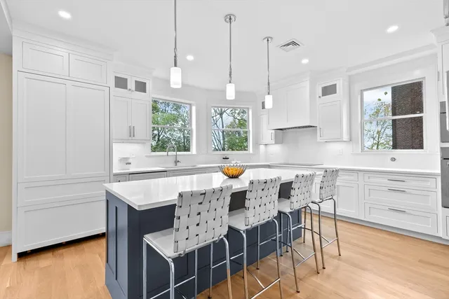 a kitchen with a table chairs sink and cabinets