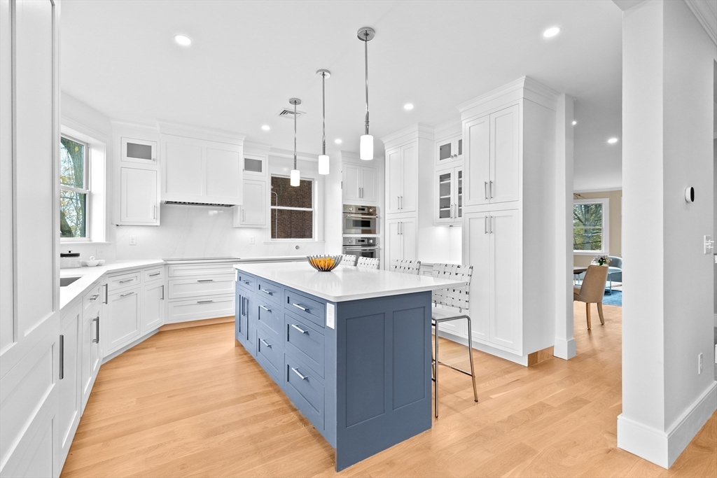 90 Addington Road, Unit 1 Brookline, MA 02445 - Photo 4 of 21 a large kitchen with a large counter top a sink stainless steel appliances and cabinets