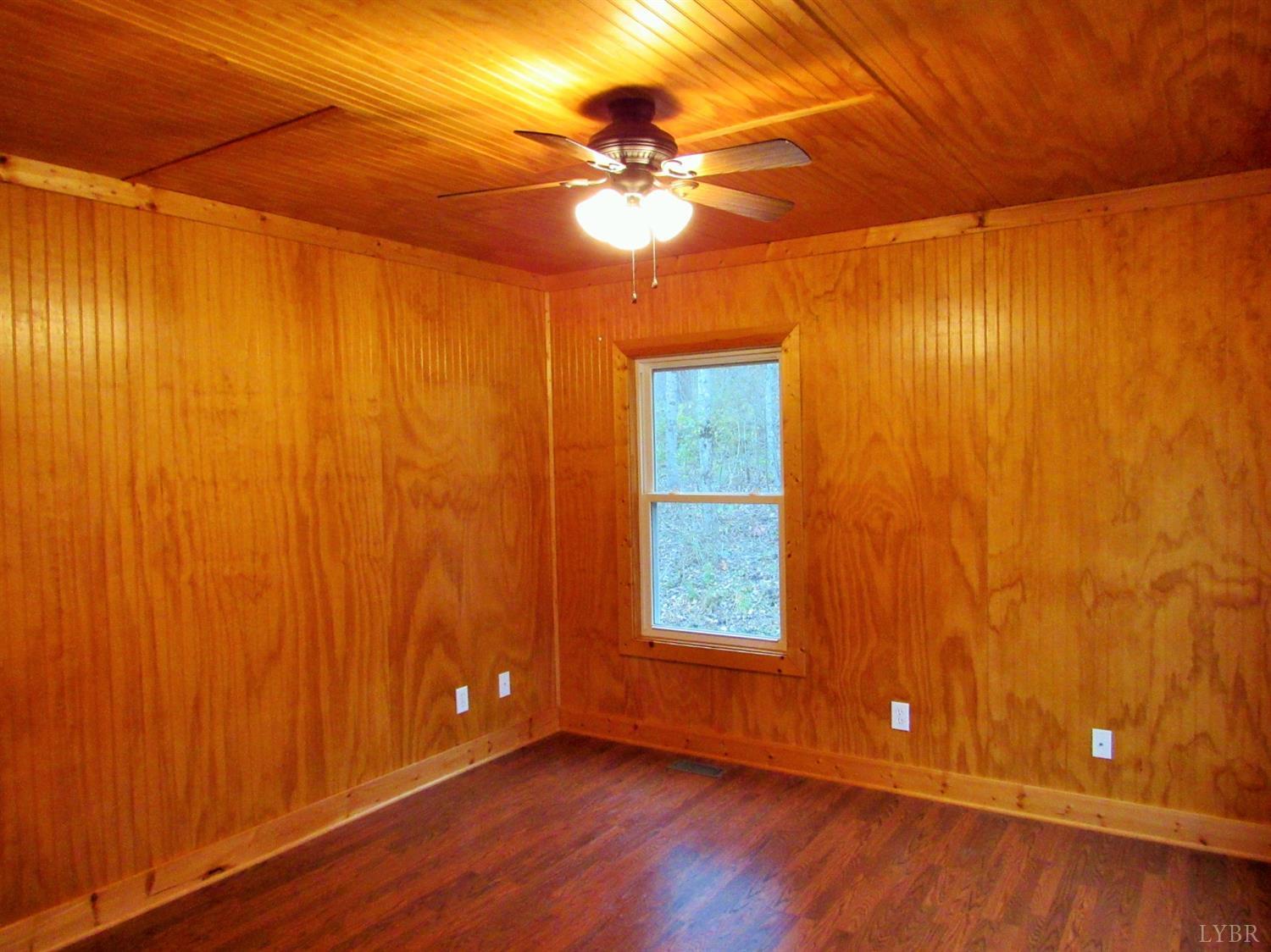 1695 Stapleton Road Madison Heights, VA 24572 - Photo 13 of 25 an empty room with windows and chandelier fan