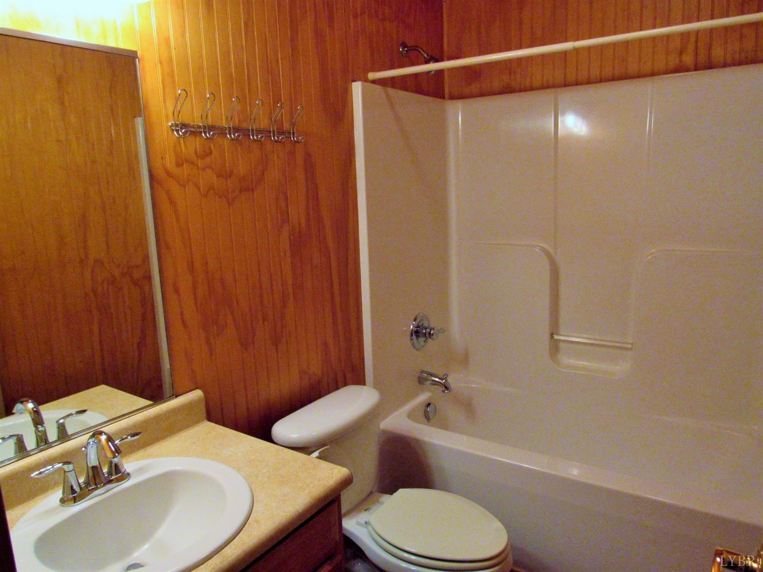 1695 Stapleton Road Madison Heights, VA 24572 - Photo 14 of 25 a bathroom with a sink toilet and shower