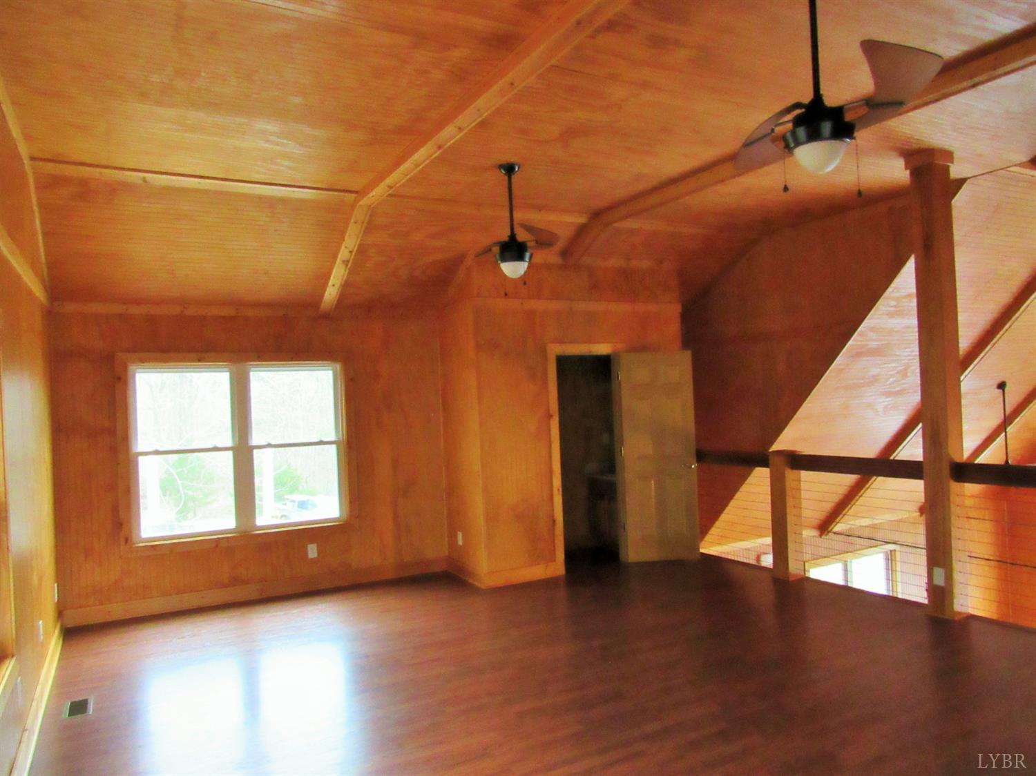 1695 Stapleton Road Madison Heights, VA 24572 - Photo 15 of 25 a view of empty room with wooden floor and fan