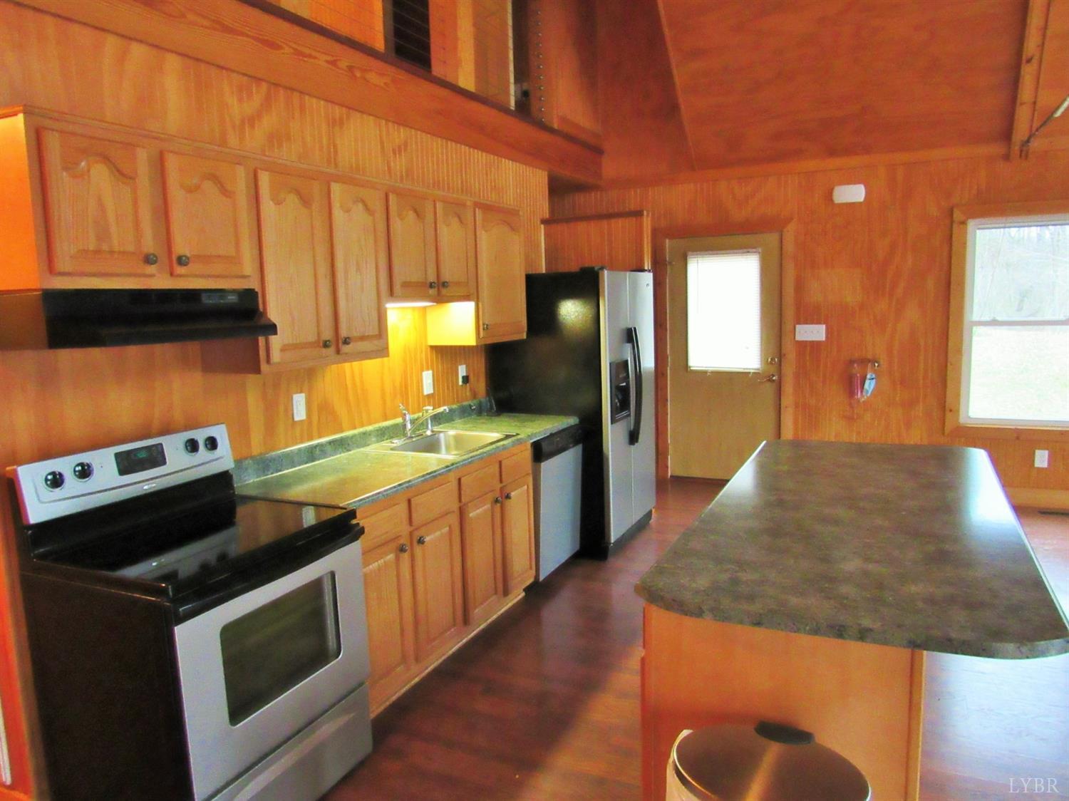 1695 Stapleton Road Madison Heights, VA 24572 - Photo 10 of 25 a kitchen with stainless steel appliances granite countertop a stove a sink and a microwave