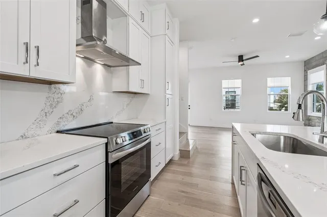 a view of a room with a ceiling fan and window