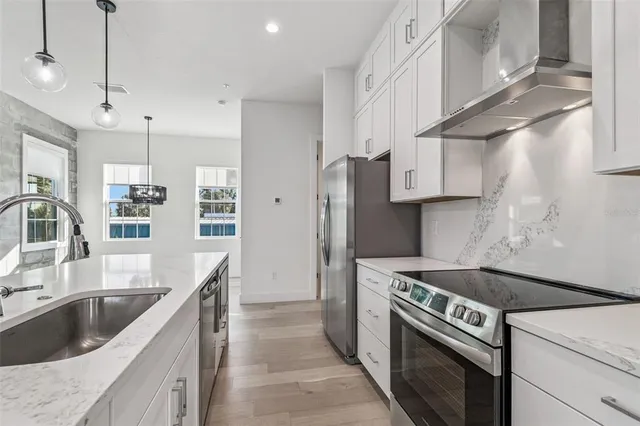 a view of a kitchen with a refrigerator and a window