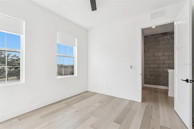 an empty room with windows and closet