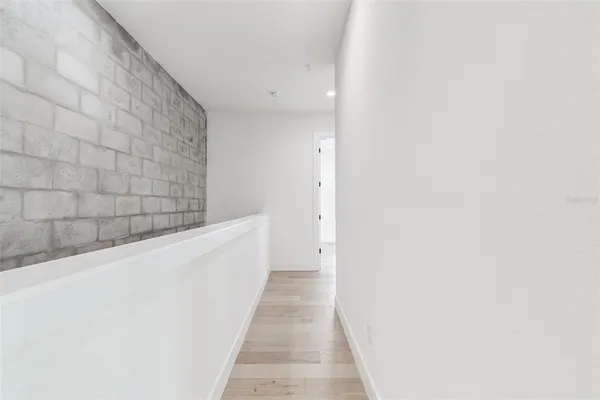 a white toilet sitting next to a white wall