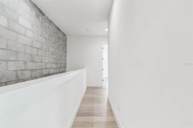 a white toilet sitting next to a white wall