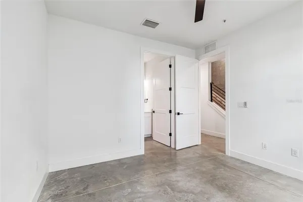 a bath tub sitting next to a white sink and vanity