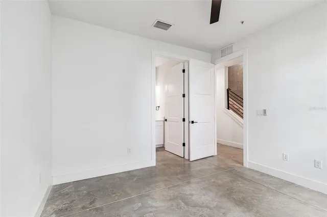 a bath tub sitting next to a white sink and vanity