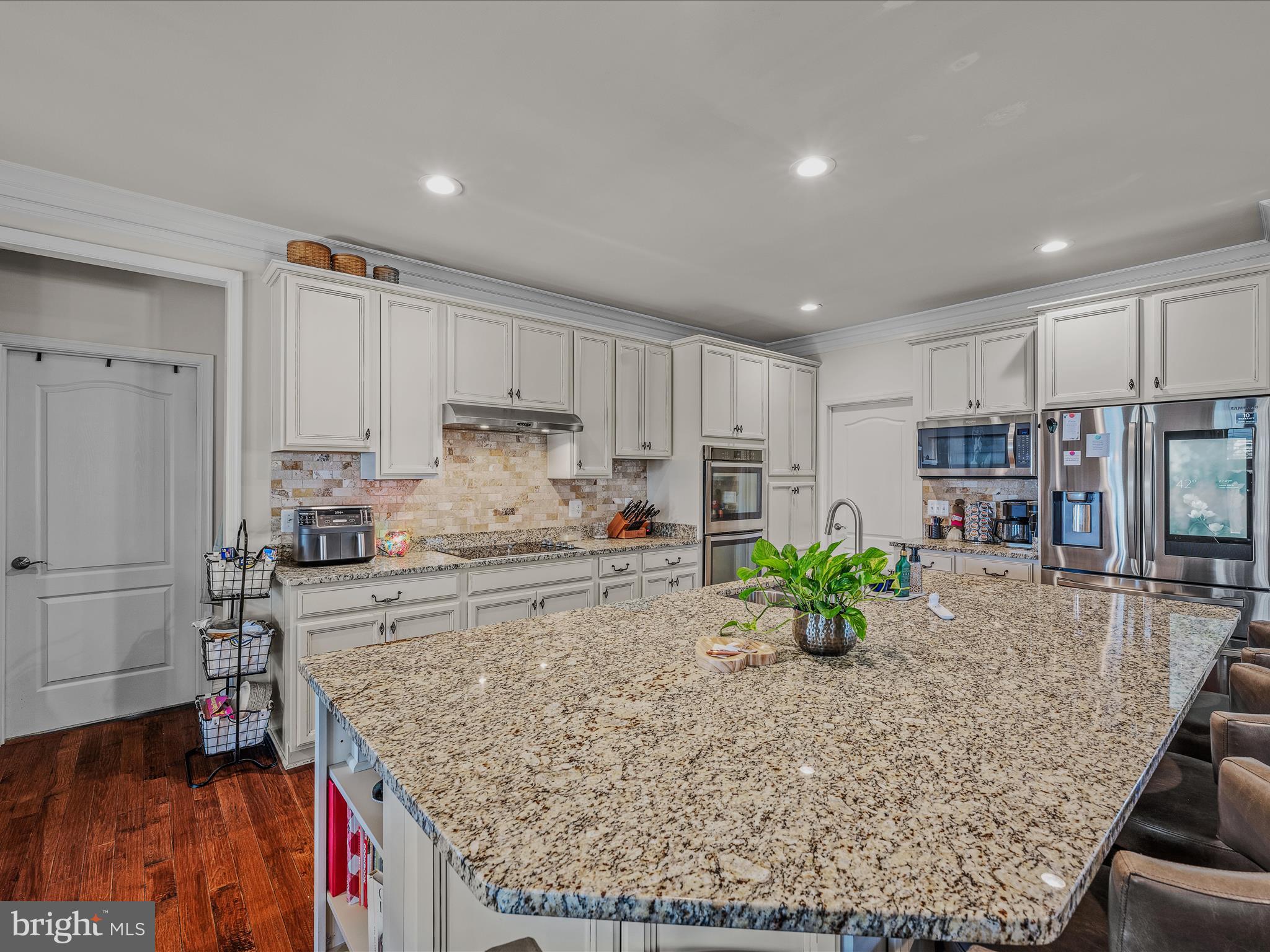 258 Tributary Trail Falling Waters, WV 25419 - Photo 15 of 89 a kitchen with stainless steel appliances granite countertop a table and chairs in it