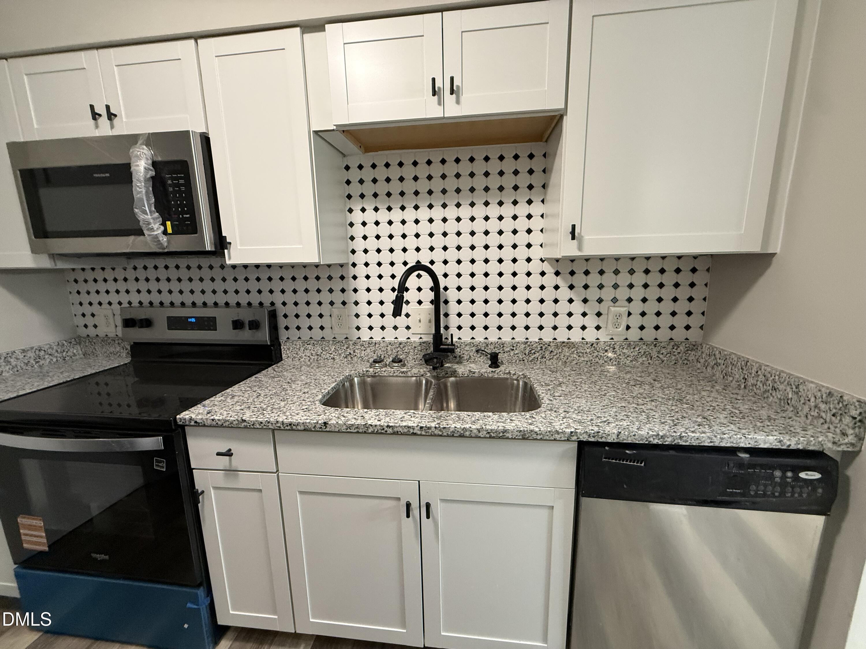 1114 Schaub Drive, Unit I Raleigh, NC 27606 - Photo 7 of 9 a kitchen with a sink and a microwave