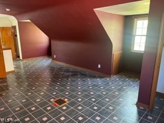 13210 Rockside Road Garfield Heights, OH 44125 - Photo 13 of 15 Bonus room featuring vaulted ceiling and dark tile flooring