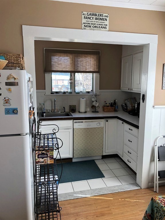 44 Sculpin Way, Unit 44 Swampscott, MA 01907 - Photo 12 of 21 a kitchen with a sink a refrigerator and cabinets